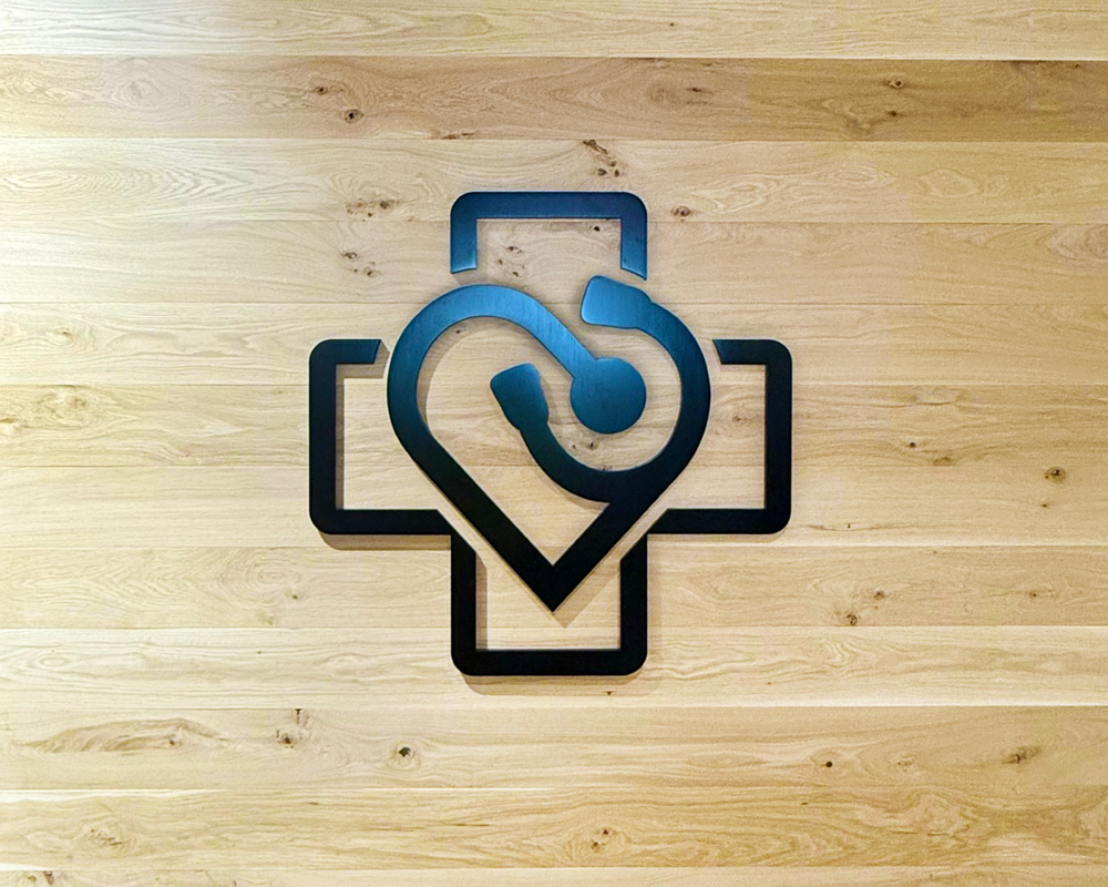 Logo of Lafayette Hospital + Clinics on a wooden wall.