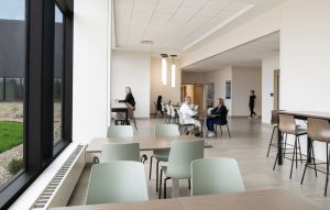 People sitting at tables eating at Lafayette Hospital's cafe