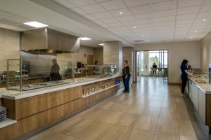 People ordering food at a cafe counter at Lafayette Hospital